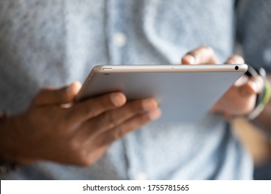 Close up hands African man holding digital tablet device. E-commerce websites buy in internet on-line stores usage, typing e-mail to client, reading sending message to friends, e-date website concept - Shutterstock ID 1755781565