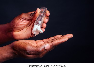 close up hands of afro male useing antiseptic in studio black background. - Shutterstock ID 1547526605