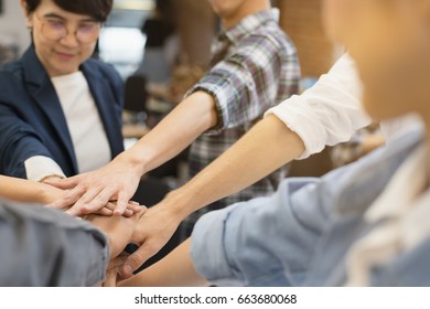 Close Up Hand's Asian Group Professional Colleagues Join Hands Together At Modern Office Workplace. Team Professional Start Meeting And Brainstorm.