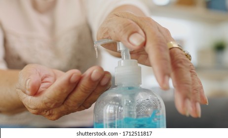 Close up Hands of Asian senior woman using alcohol gel for hands washing - Powered by Shutterstock