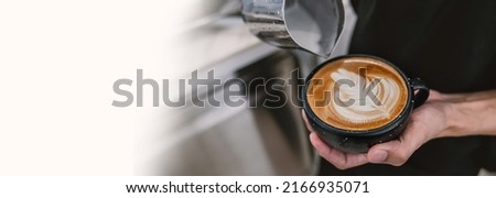 Close up hands of barista make coffee latte art with coffee espresso machine in coffee shop cafe in vintage color tone. Morning routine aroma coffee lifestyle urban people concept.