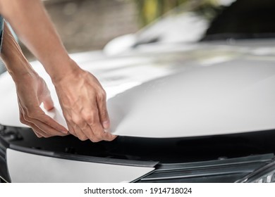 Close up of hands being open the car hood or bonnet for maintenance checking engine  before a trip or journey, Car check condition concept.