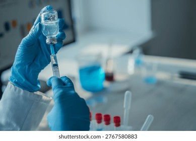 Close up of hands in blue gloves preparing an injection with a syringe and vial, surrounded by laboratory equipment. The image emphasizes medical research, vaccination, and scientific innovation