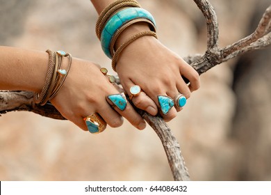 close up hands with boho accessories
