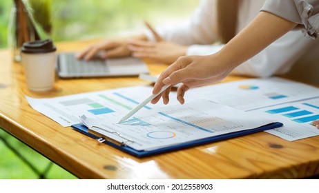 Close up hands, businesspeople talking about their financial plan and explain about business feasibillity - Shutterstock ID 2012558903