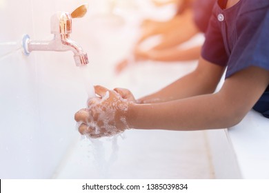 close up hands of children or Pupils At preschool Washing hands with soap under the faucet with water,copy space for text or product you. clean and Hygiene concept. - Shutterstock ID 1385039834