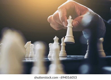 Close up of hands confident businessman colleagues playing chess game to development analysis new strategy plan, leader and teamwork concept for success. - Powered by Shutterstock