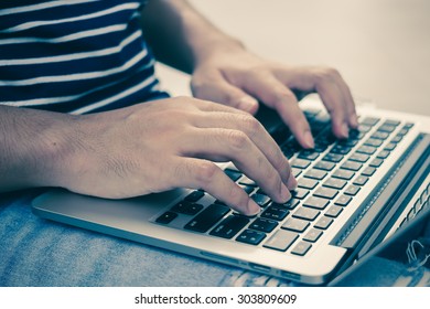 close up hands of creative man typing on laptop concept