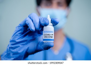 Close up Hands of Doctor or nurse holding Intranasal vaccine spary bottle for coronavirus or covid-19 pandemic.