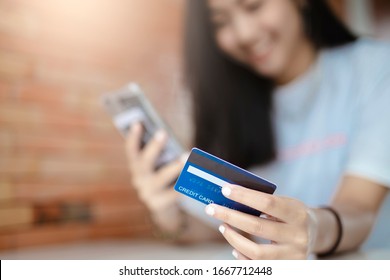 Close Up Hands Holding Credit Card And Using Mobile Smart Phone Outdoor, Online Shopping, Woman Happy.(credid Card Mockup)