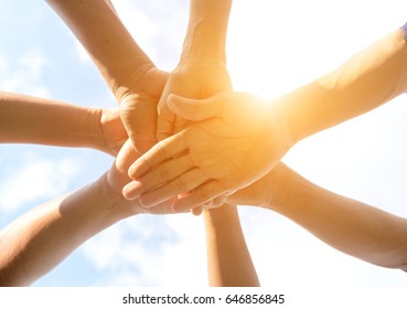 Close Up Hands Holding Many People  Team For Together On Blue Sky Background.  Teamwork Concept

