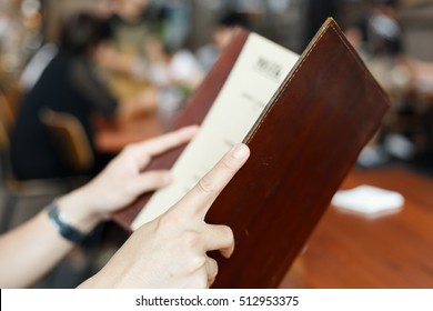 Close Up Hands Holding Restaurant Menu For Dinner Dating.