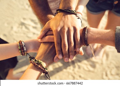 Close up of hands holding together at the beach - Powered by Shutterstock