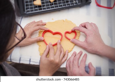 Close Up Hands Of Little Asian Girl And Her Mother Baking Cutter Cookies Heart Shape In The Kitchen. Happy Asian Family And Mother'?s Day Concept. Background And Banner