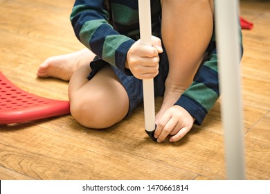 Close Up Of Hands Of Little Boy Assembling Non Slip Chair Leg Cap With Focus And Concentration. Child Development, Hand And Eye Coordination, Cognitive Skill, Life Skills, DIY Furniture.