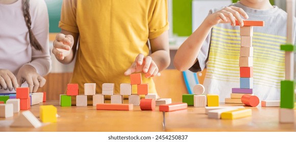 close up hands of little children playing blocks in classroom. Learning by playing education group study concept. International pupils do activities brain training in primary school background banner - Powered by Shutterstock - Get 15% off with code: PIKWIZARD15