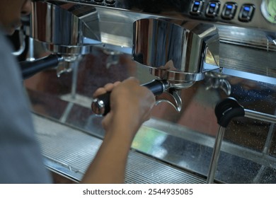 Close up of hands making coffee.