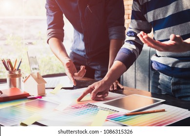 Close up hands male graphic designers,interior designer. Meeting on graphic tablet in modern space office.discussion data new start up project of graphics design style and graphics design diagram
