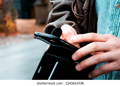 Close up of hands of a man checking his smartphone