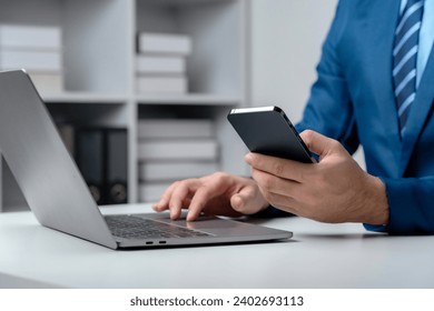 Close up of hands man hand using smartphone typing, chatting conversation in chat box. Man hands using smartphone in office, messaging or browsing social networks.