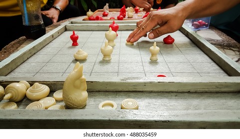 Close up of hands of man playing chess. 