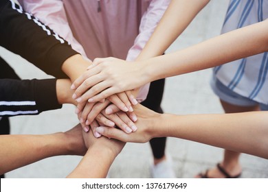 Close up at the hands many teenage girls. Show unity as a collaborative work together. To succeed, one has to understand each other in communication. Concept International Women's Day - Shutterstock ID 1376179649