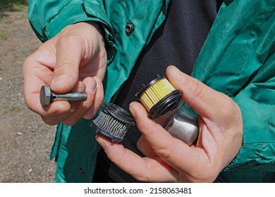 Close Up Hands Of Mechanic With Old Dirty And New Clean Filters Doing Car Maintenance And Repair. Replacing The Gas Filter. Car Service Concept.