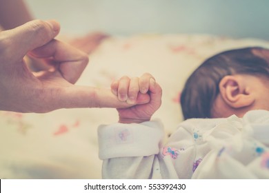  Close up hands of mother and baby 