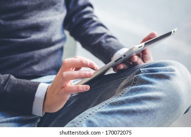 close up hands multitasking man using tablet, laptop and cellphone connecting wifi - Powered by Shutterstock