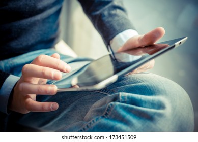 close up hands multitasking man using tablet, laptop and cellphone connecting wifi - Shutterstock ID 173451509