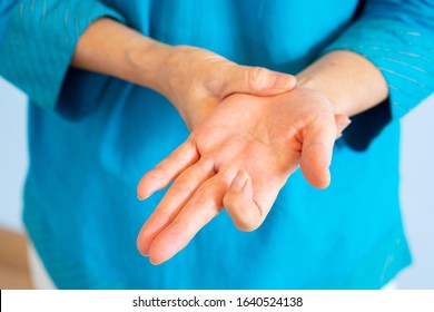 close up hands of older woman getting trigger finger from working
