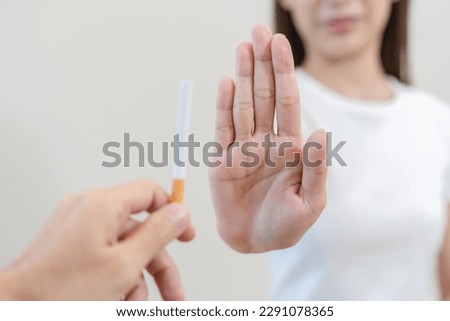 Close up hands of person refusing to smoke cigarette.