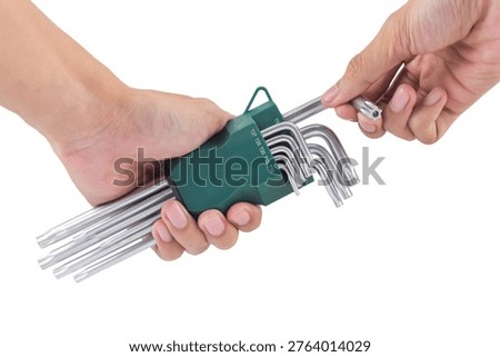 Close up of hands picking a torx key from a green star hex key set, isolated on white background.