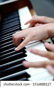 Close up of hands playing the piano  - Shutterstock ID 1516888127