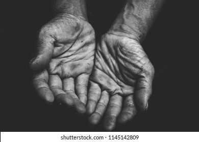 Close Up Hands Poor Old Man Or Beggar Begging You For Help Sitting At Dirty Slum. Concept For Poverty Or Hunger People,human Rights,donate And Charity,background Text.lowkey,black And White Tone.