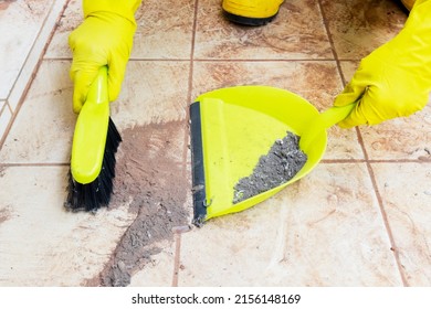 Close Up Of Hands Sweeping Dust On The Floor With Whisk Broom And Dustpan At Dirty Home