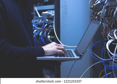 Close up of hands technician working on laptop in data center.Administrator working in data center configure . - Shutterstock ID 1221255337