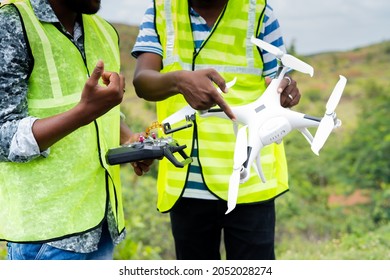 close up hands of Unrecognizable Trainer teaching by explaining about drone operations to student - Concept drone or UAV pilot training - Powered by Shutterstock