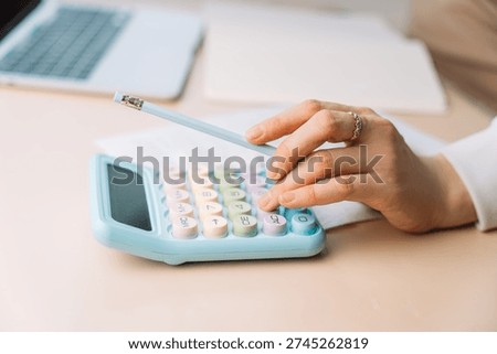 Close up hands using calculator on desk, financial calculation and expense tracking