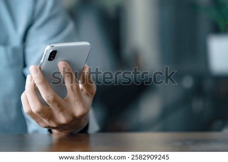 Close up hands using cellphone searching on internet