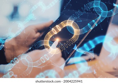 Close up of hands using digital pad with creative glowing blockchain hologram on blurry desktop background. Cryptocurrency and innovation concept. Double exposure