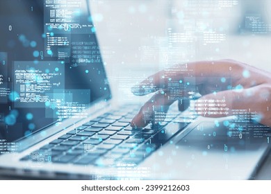 Close up of hands using laptop with creative binary coding hologram on blurry background. Software programming code. Double exposure
