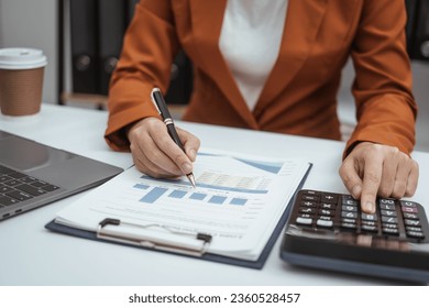 Close up hands of woman in brown formal suit checking bills, taxes, bank account balance, using calculator, Personal Checking, Empower Checking, Personal Savings, Certificates, IRAs, Money Market