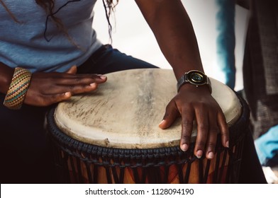 Close up of hands of a woman playing a drum. Nigerian woman playing a traditional African drum - Powered by Shutterstock