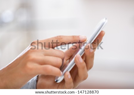 Close up of hands woman using cell phone.