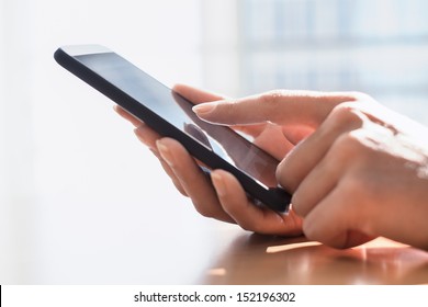 Close up of hands woman using her cell phone. indoor