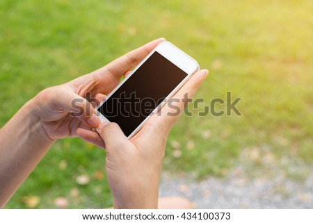 Close up of hands woman using smart phone in the city