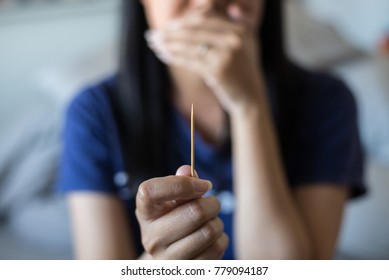 Close up of hands woman using toothpick wooden