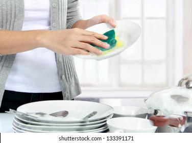 close up hands of Woman Washing Dishes in the kitchen