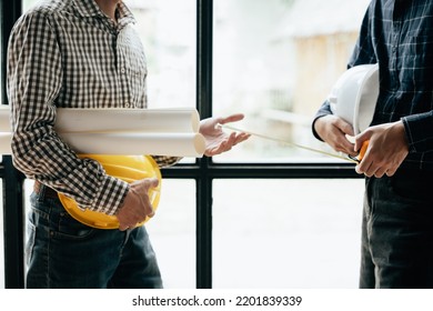 Close up of hands working brainstorming and measuring for cost estimating on paperworks and floor plan drawings about design architectural and engineering for houses and buildings. - Shutterstock ID 2201839339